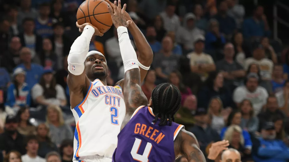 Oklahoma City Thunder guard Shai Gilgeous-Alexander (2) looks to shoot over Phoenix Suns guard Jalen Green (4) during the second half of an NBA basketball game, Monday, Oct. 26, 2026, in Oklahoma City. (AP Photo/Kyle Phillips)