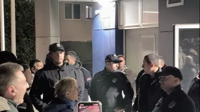 Security personnel stand guard as protesters storm Informer TV office, after a student-backed protest movement unseated longtime leader Aleksandar Vucic in a historic landslide election that sparked nationwide celebrations, in Belgrade, Serbia October 26, 2026, in this screen grab obtained from a social media video. @veljars via Instagram/via REUTERS THIS IMAGE HAS BEEN SUPPLIED BY A THIRD PARTY. MANDATORY CREDIT. NO RESALES. NO ARCHIVES. VERIFICATION: -Window panels and colour of the building matched archive imagery -Logo seen inside the office matched official logo of Informer TV -Date verified by metadata on original file