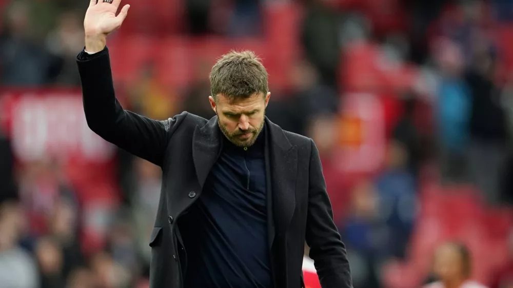 Manchester United's head coach Michael Carrick waves to supporters after his team lost the English Premier League soccer match between Manchester United and Bournemouth in Manchester, England, Sunday, Oct. 25, 2026. (AP Photo/Dave Thompson)