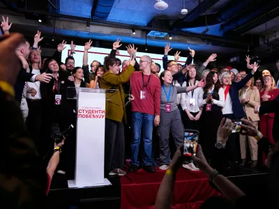 Candidate of the Students' List celebrate on stage along with staff members after polls closed in the parliamentary election in Belgrade, Serbia, Sunday, Oct. 25, 2026. (AP Photo/Petr David Josek)