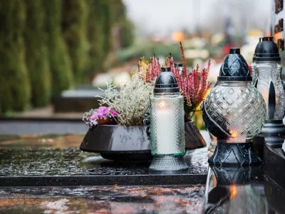 All Saints' Day and burning candles and flowers on the graves.Candles on graves symbolize the memory of the dead on November 1.Catholic cemetery during All Saints' Day.Selective focus.