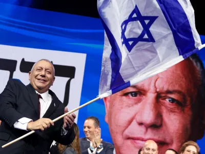Former military chief Gadi Eisenkot, leader of the Yashar party, waves an Israeli flag following the exit polls at his party headquarters, on the evening of Israel's national election, in Tel Aviv, Israel October 28, 2026. REUTERS/Shir Torem   TPX IMAGES OF THE DAY