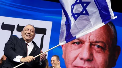 Former military chief Gadi Eisenkot, leader of the Yashar party, waves an Israeli flag following the exit polls at his party headquarters, on the evening of Israel's national election, in Tel Aviv, Israel October 28, 2026. REUTERS/Shir Torem   TPX IMAGES OF THE DAY