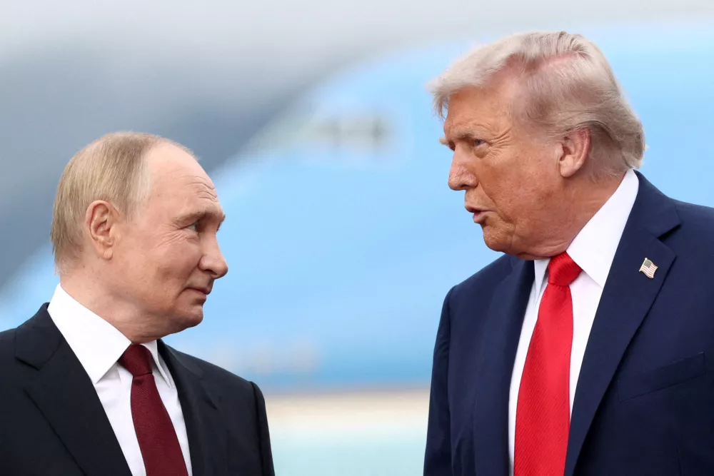 FILE PHOTO: US President Donald Trump speaks with Russian President Vladimir Putin, as they meet to negotiate for an end to the war in Ukraine, at Joint Base Elmendorf-Richardson in Anchorage, Alaska, US, August 15, 2025. REUTERS/Kevin Lamarque/File Photo