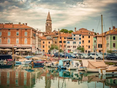 St. Maurus's Parish Church and Bell Tower Reflected in the Calm Waters of Izola Harbor, Slovenia