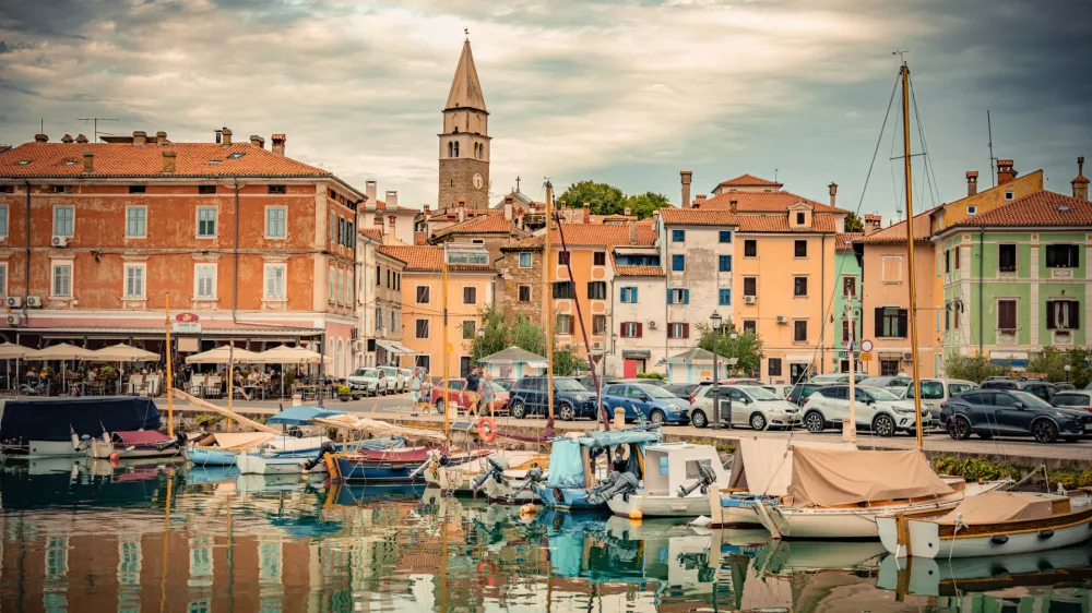St. Maurus's Parish Church and Bell Tower Reflected in the Calm Waters of Izola Harbor, Slovenia