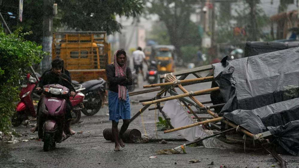 A man walks past the destruction caused at Kakinada, India, after Cyclone Arnab crossed the Andhra Pradesh coast in the early hours of Wednesday, Oct. 28, 2026. (AP Photo/Mahesh Kumar A.)