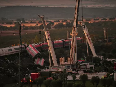 Cranes lift wrecked train carriages as rescuers search for victims following a collision between two trains in Urda, Spain, Thursday, Oct. 29, 2026. (AP Photo/Manu Fernandez)