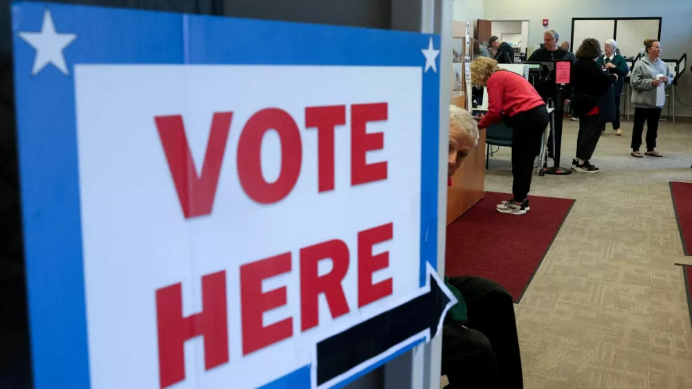 FILE PHOTO: People cast ballots and register as early voting begins in Ohio, with former US Senator Sherrod Brown (D-OH) and Senator Jon Husted (R-OH) engaged in the second-most-expensive Senate race in the country, inside the Medina County Board of Elections in Medina, Ohio, US, October 6, 2026. REUTERS/Shannon Stapleton/File Photo
