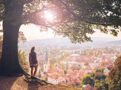 Female tourist enjoying sunset above city of ljubljana panoramic view- Slovenia