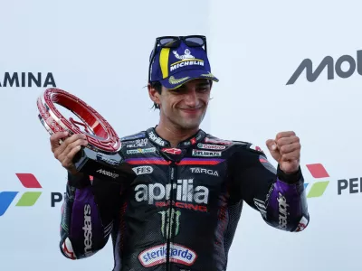 FILE PHOTO: MotoGP - Indonesian Grand Prix - Mandalika International Street Circuit, Mandalika, Indonesia - October 11, 2026 Third place Aprilia Racing's Jorge Martin celebrates on the podium with a trophy after the MotoGP race REUTERS/Willy Kurniawan/File Photo