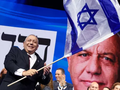 Former military chief Gadi Eisenkot, leader of the Yashar party, waves an Israeli flag following the exit polls at his party headquarters, on the evening of Israel's national election, in Tel Aviv, Israel October 28, 2026. REUTERS/Shir Torem   TPX IMAGES OF THE DAY