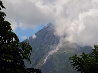 Mayon Volcano spews white smoke as seen from Daraga, Albay province, central Philippines on Thursday June 8, 2023. The Philippine Institute of Volcanology and Seismology raised Thursday the status of Mayon Volcano in Albay to Alert Level 3 due to "increased tendency towards a hazardous eruption." (AP Photo/John Michael Magdasoc)