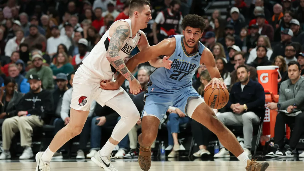 Memphis Grizzlies forward Cameron Boozer, right, drives to the basket as Portland Trail Blazers guard V&iacute;t Krejč&iacute;, left, defends during the first half of an NBA basketball game Thursday, Oct. 29, 2026, in Portland, Ore. (AP Photo/Amanda Loman)