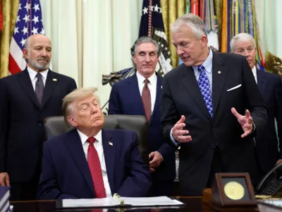 FILE PHOTO: US Senator Dan Sullivan (R-AK) speaks about an energy infrastructure project in Alaska as US President Donald Trump listens in the Oval Office at the White House in Washington, D.C., US, September 30, 2026. REUTERS/Kevin Lamarque/File Photo