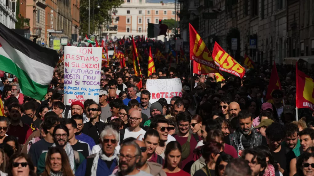 Workers, students and activists demonstrate during a nationwide general strike called by grassroots unions to protest rising living costs, low wages and military spending, Friday, Oct. 30, 2026, in Rome. (AP Photo/Alessandra Tarantino)