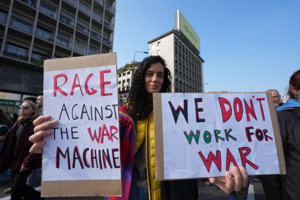 Workers, students and activists demonstrate during a nationwide general strike called by grassroots unions to protest rising living costs, low wages and military spending, Friday, Oct. 30, 2026, in Milan. (AP Photo/Antonio Calanni)