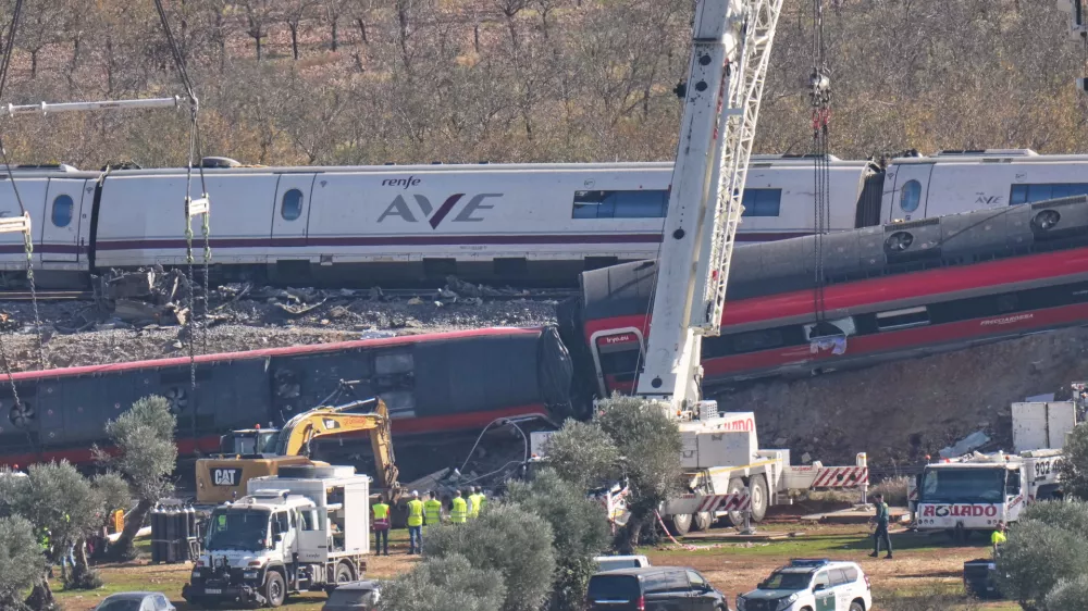 A crane operates at the site of wrecked train carriages following a collision between two trains in Urda, Spain, Friday, Oct. 30, 2026. (AP Photo/Bernat Armangue)