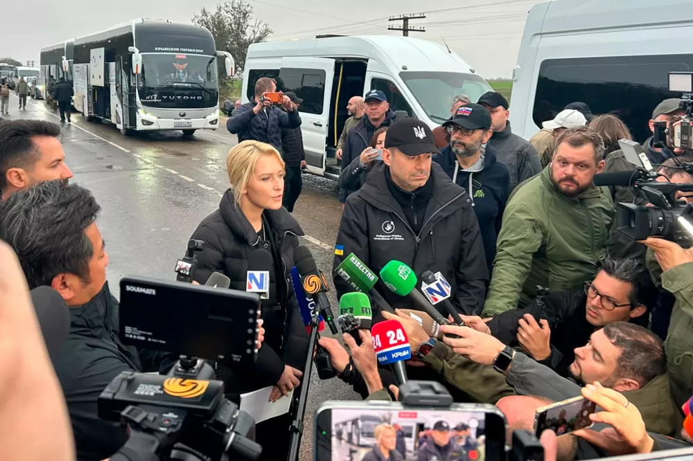 In this photo provided by the Office of the Ombudsman of Ukraine, Ukraine's Ombudsman Dmytro Lubinets, center left, and Russian Ombudsman Yana Lantratova speak with journalists before departing for Oleshky to evacuate local residents to a safe area during a local ceasefire linked to a humanitarian mission in Ukraine's Kherson region, Friday, Oct. 30, 2026. (Office of the Ombudsman of Ukraine via AP)