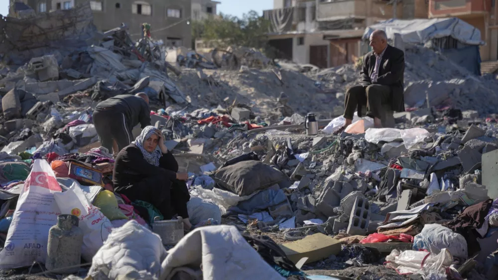 Palestinians search through the rubble of a building destroyed in an overnight Israeli strike in the Bureij refugee camp, in the central Gaza Strip, Friday, Oct. 30, 2026. (AP Photo/Abdel Kareem Hana)