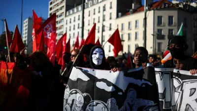 A protester wears Guy Fawkes mask during a demonstration organised by labour unions as part of nationwide protests called by the "Yellow Vests" movement joined by French high school and university students against the cost of living and rising fuel prices, in Paris, France, October 31, 2026. REUTERS/Pedro Nunes
