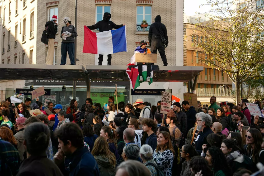 People attend protests over living costs and education in Paris, France, Saturday, Oct. 31, 2026. (AP Photo/Teresa Suarez)