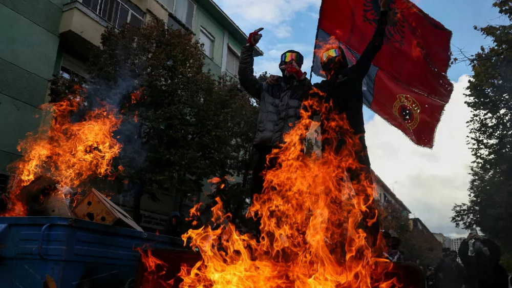 Protesters gesture next to burning baricade during an anti-government protest in Tirana, Albania, October 31, 2026. REUTERS/Florion Goga