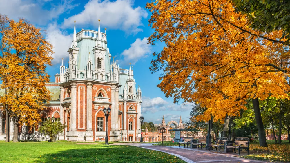 Part of the palace in Tsaritsyno in Moscow on a bright sunny autumn day and a great golden tree